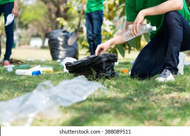 Cropped image of environmental activists collecting garbage - Powered by Shutterstock