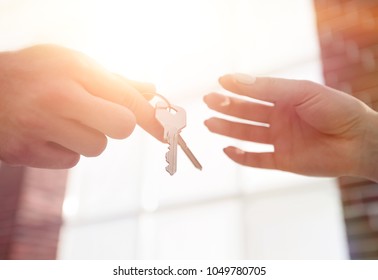 Cropped Image Of Estate Agent Giving House Keys To Man In Office