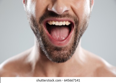 Cropped Image Of An Excited Bearded Mans Half Face With Naked Shoulders And Open Mouth Isolated Over White Background