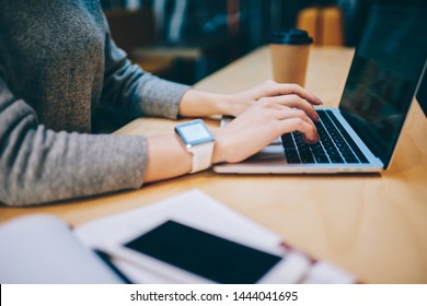 Cropped Image Of Female Hands Typing Text Information On Keyboard Of Modern Laptop Computer During Distance Job In Coffee Shop,skilled Freelancer Searching Website With Info About Settings For Netbook