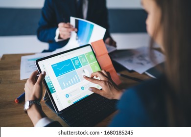 Cropped image of female professional checking financial website with revenue statistics and marketing infographics, expert woman browsing web page with graph charts of corporate monetary gain