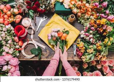 cropped image of florist wrapping bouquet in pack paper in shop - Powered by Shutterstock