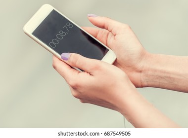 Cropped Image Of Girl Using Timer On A Smart Phone For Morning Run