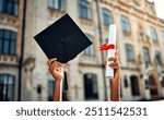  Cropped image of graduate holding academic hat and diploma with red ribbon. Happy graduation, bright future, success and confidence.   