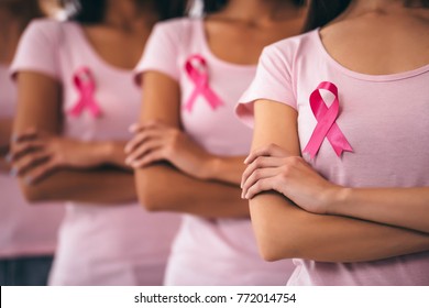 Cropped image of group of young multiracial woman with pink ribbons are struggling against breast cancer. Breast cancer awareness concept. - Powered by Shutterstock