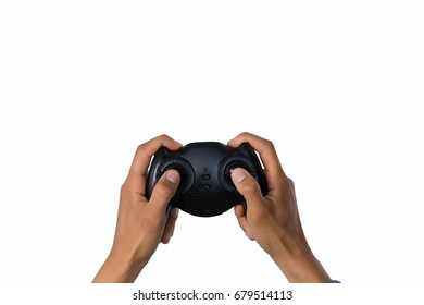 Cropped image of hand holding controller against white background