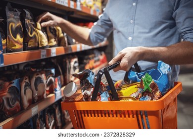 Cropped image of handsome man with a market basket doing shopping at the supermarket - Powered by Shutterstock