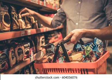 Cropped Image Of Handsome Man With A Market Basket Doing Shopping At The Supermarket