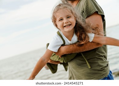 Cropped image of happy father and daughter playing and having fun together on beach. Happy father`s day! Fatherhood and parenting concept - Powered by Shutterstock