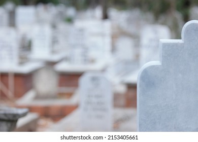 Cropped image of headstone at Muslim cemetery. Background of blurred graveyard. - Shutterstock ID 2153405661