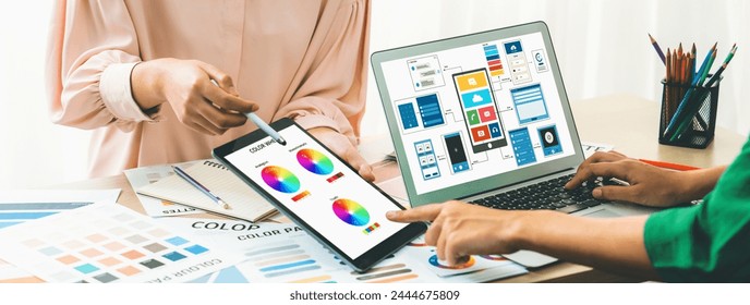 Cropped image of interior designer team presents color by using color palette while laptop displayed UI and UX designs for mobiles app and website. Creative design and business concept. Variegated. - Powered by Shutterstock