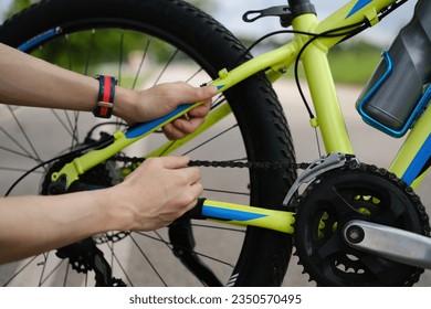 Cropped image of male cyclist checking tire or transmission system of his mountain bike - Powered by Shutterstock