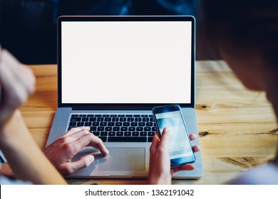 Cropped image of male and female hands using technology for communication online, man searching information on website via laptop computer with blank screen area for your internet advertising