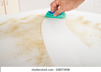 Cropped Image Of Male Janitor Cleaning Counter With Detergent Spray Bottle And Sponge