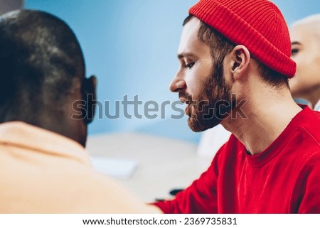 Cropped image of male students consulting with each other doing project for homework together