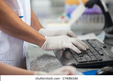 Cropped Image Of Male Technician Using Computer In Medical Laboratory
