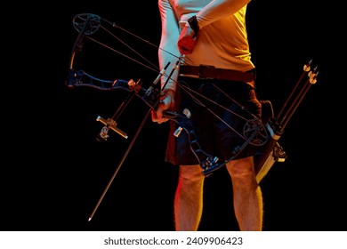 Cropped image of man with archery equipment against black studio background in neon light. Concept of professional sport and hobby, competition, action, game - Powered by Shutterstock