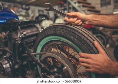 Cropped Image Of  Man Repairing A Motorcycle In The Repair Shop