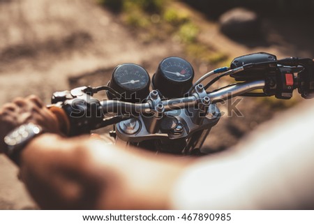 Similar – Senior man steering motorcycle on road