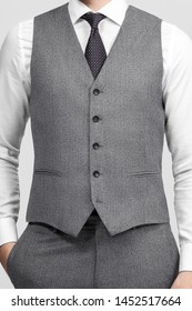cropped image of a man in a suit without jacket, in waistcoat with one hand in his pocket. front view
