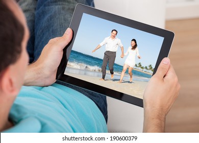 Cropped Image Of Man Watching Movie On Digital Tablet At Home