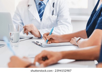 Cropped image of medical professional meeting in hospital office. Interns medical workers on lecture studying taking notes about diagnoses, medical history, listening to doctor professor - Powered by Shutterstock