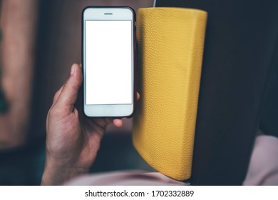 Cropped image of millennial student using cellphone gadget with copy space area for internet advertising for online chatting, selective focus on modern mocking smartphone with blank touchscreen