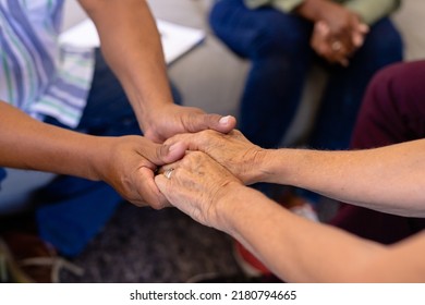 Cropped image of multiracial senior friends holding hands and comforting in group therapy session. Nursing home, sadness, console, unaltered, stress, together, support, assisted living, retirement. - Powered by Shutterstock