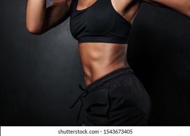 Cropped image of muscular african american woman in sportswear and hand wraps running isolated over black background - Powered by Shutterstock