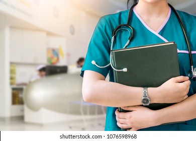Cropped image of nurse in purple uniform holding green book on white background.Nurse, Student, Education