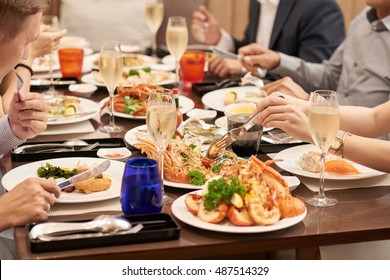 Cropped Image Of People Eating Various Seafood