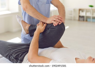 Cropped image of a physiotherapist massaging and kneading a patient's leg provides medical care for sprained ligaments. Concept of rehabilitation and recovery after physical leg injuries.