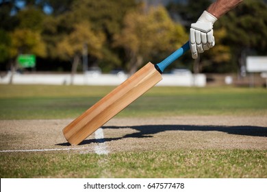 Cropped image of player scoring run on cricket field - Powered by Shutterstock
