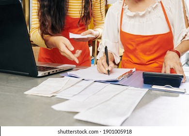 Cropped Image Of Senior Flower Shop Owner Teaching Her Adult Daughter How To Make Financial Report Or Do Bookkeeping