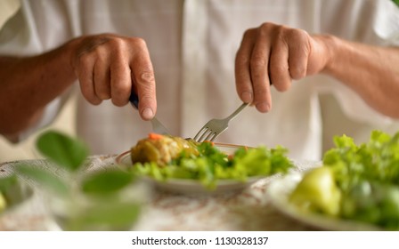 Cropped Image Of Senior Man Eating