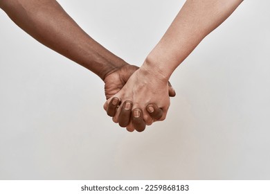 Cropped image of senior multiethnic couple holding hands. Black man and woman. Relationship and closeness. Concept of modern elderly lifestyle. Isolated on white background. Studio shoot. Copy space - Powered by Shutterstock