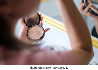 Cropped Image Side View Asian Young Woman Doing Make Up With Powder Standing In Bathroom Near Mirror. Routine Bodycare.