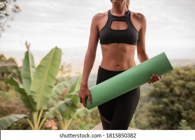 Cropped Image Slim Woman Hold In Hands Green Rolled Yoga Mat On Nature Background