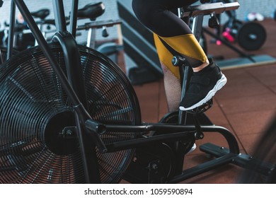 Cropped image of sportswoman doing workout on exercise bike in sports center - Shutterstock ID 1059590894