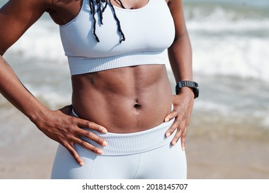 Cropped image of strong fit female body with well- defined abs - Powered by Shutterstock