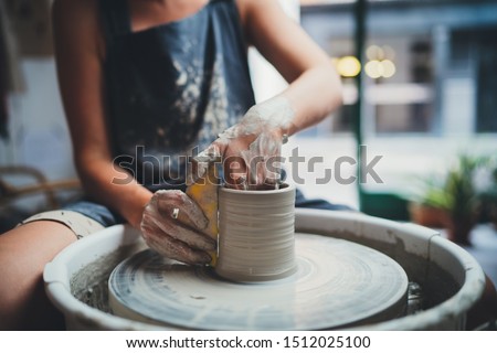 Cropped Image of Unrecognizable Female Ceramics Maker working with Pottery Wheel in Cozy Workshop Makes a Future Vase or Mug, Creative People Handcraft Pottery Class 