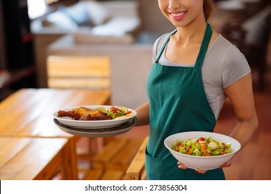 Cropped Image Of Waitress Serving Food In A Cafe