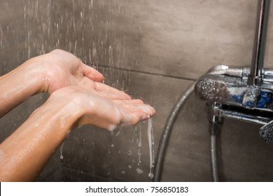 Cropped Image Of Water Drops Falling On Female Hands In The Shower
