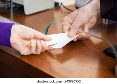 Cropped Image Of Woman Buying Movie Tickets From Male Seller At Box Office