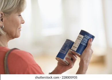 Cropped image of woman comparing products in shop - Shutterstock ID 228005935