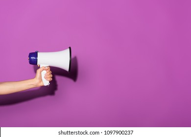 cropped image of woman holding megaphone on purple background  - Shutterstock ID 1097900237