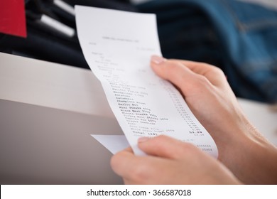 Cropped Image Of Woman Holding Receipt In Store