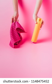 Cropped Image Of Woman Holding Spray Can And Rag, Pink Background 