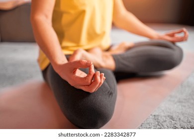 Cropped image of woman practicing yoga and meditation. Lotus pose. - Powered by Shutterstock