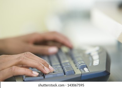 Cropped Image Of Woman's Hands Typing On A Computer Keyboard